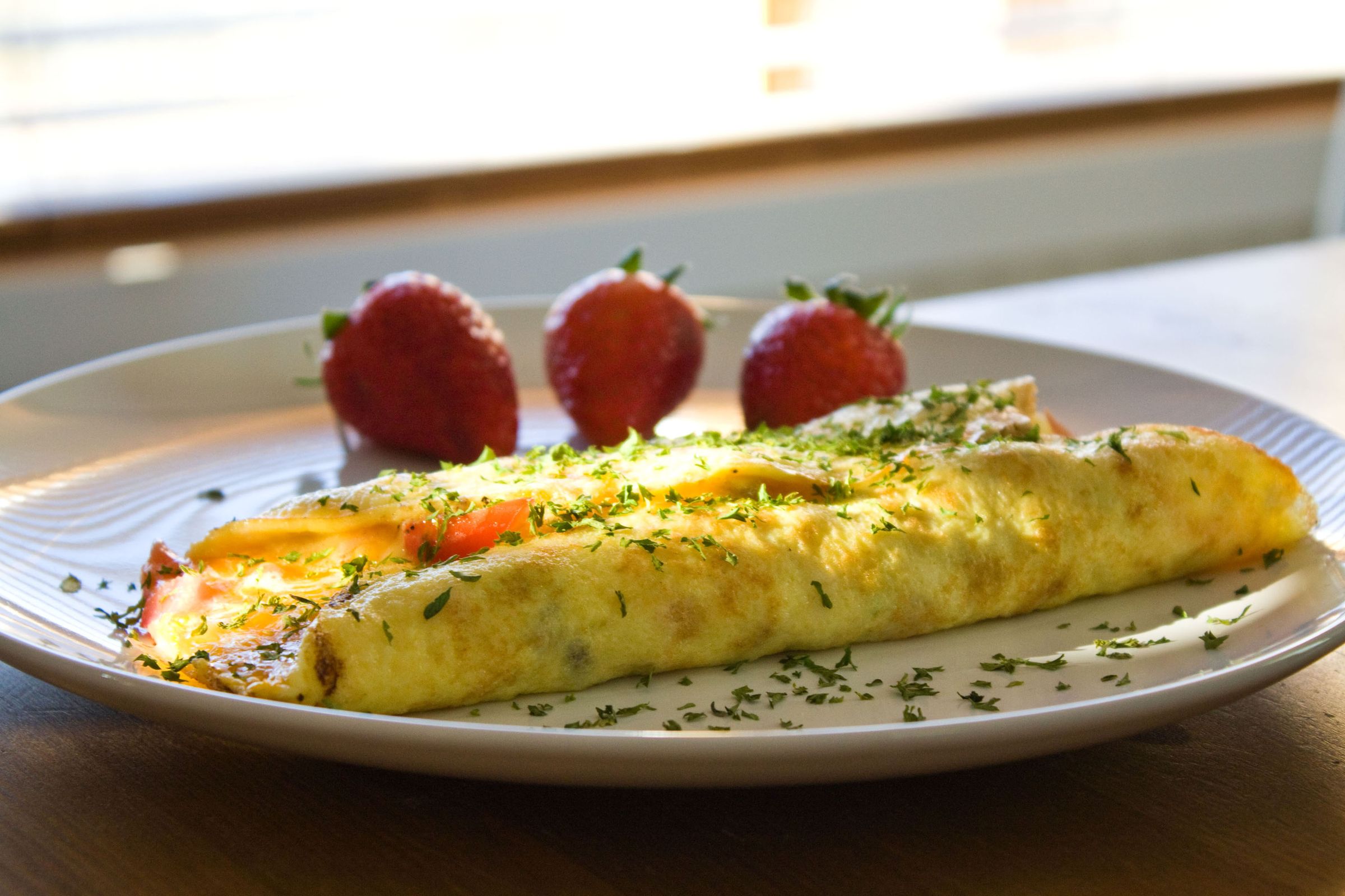 One of Steve's omelettes, plated with fresh strawberries