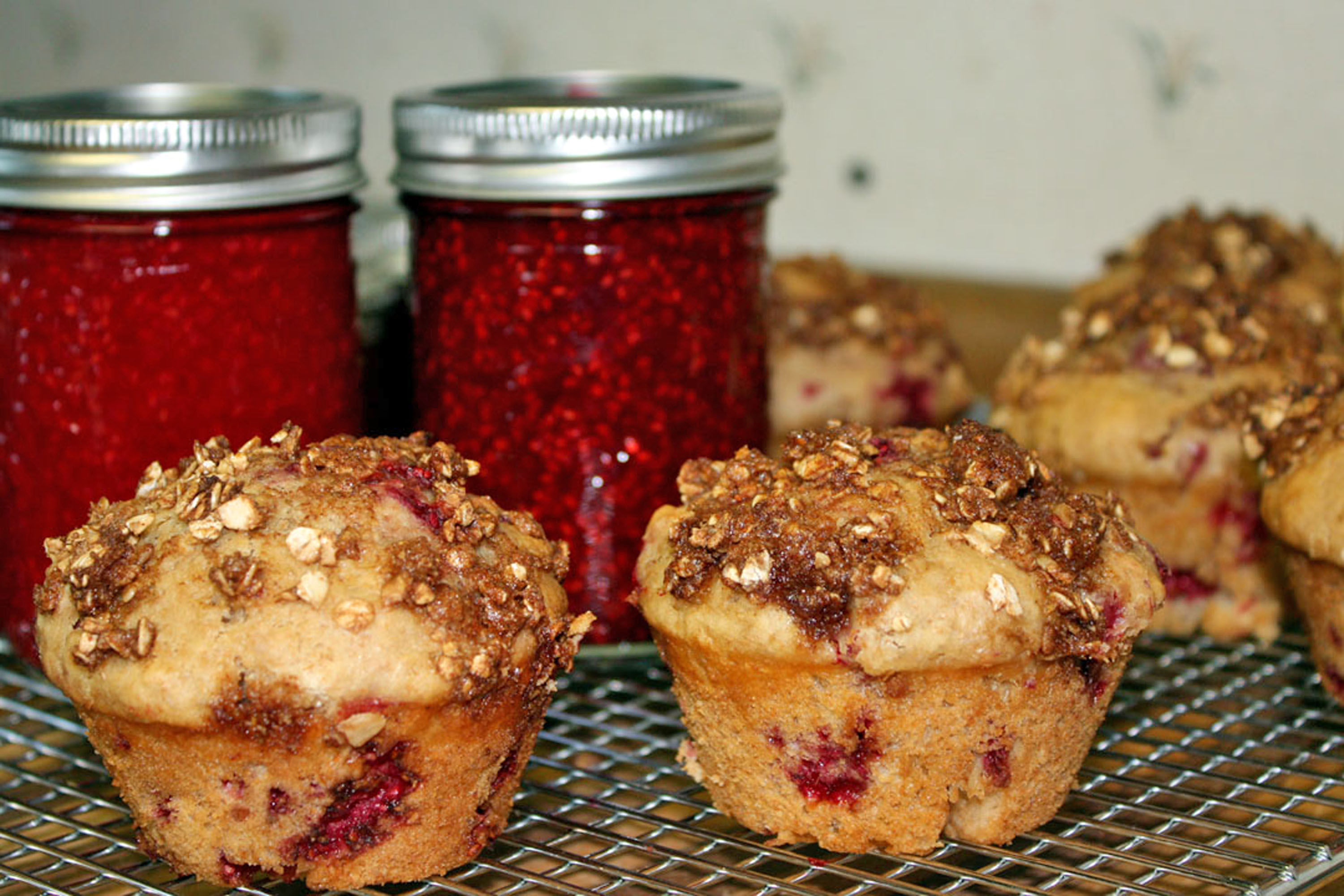 Fresh-baked muffins with a dish of homemade jam