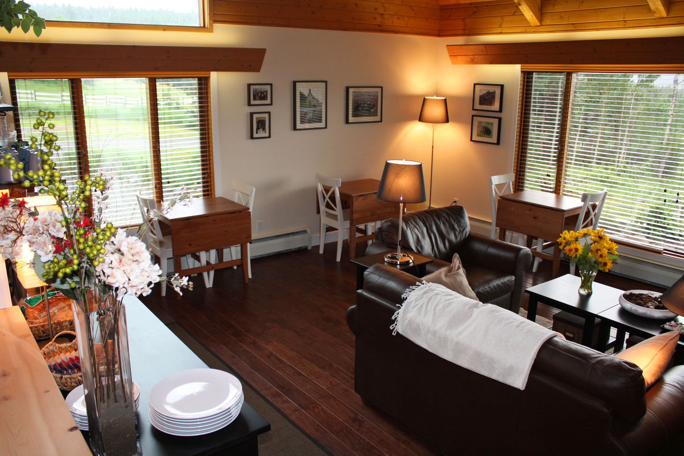 The parlour — lounge seating and a stone fireplace by tall windows, with views over the property